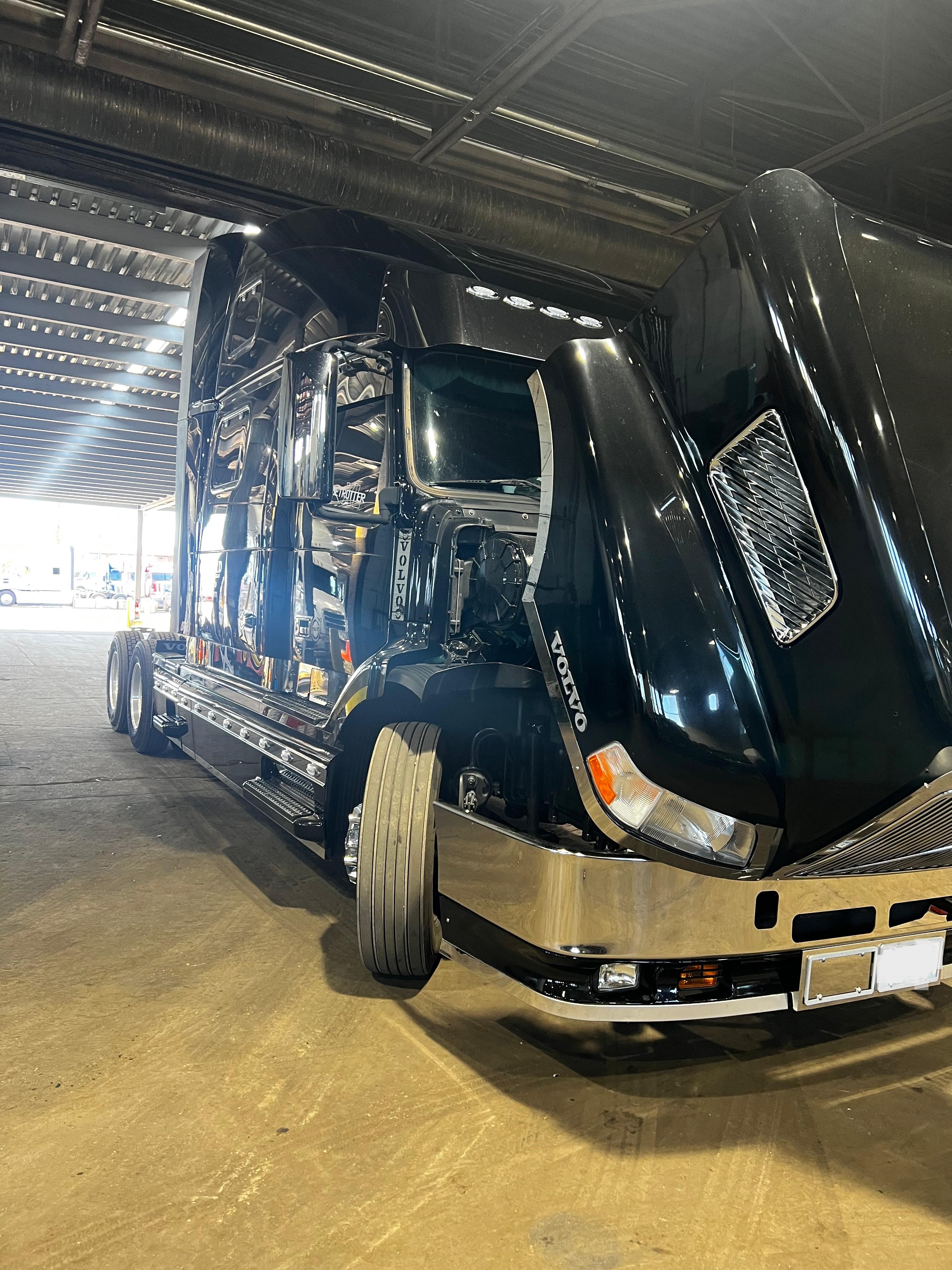 Black Volvo truck inside Somet Truck Center
